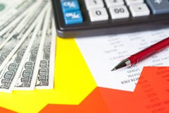 Business and financial background with dollars, data, pen and calculator. Bookkeeping background. stock image Business and financial background with dollars, data, pen and calculator. Bookkeeping background. stock image