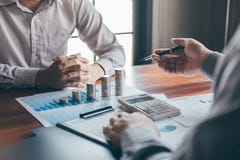 Business group brainstorming on meeting to planning project finance analyzing calculate with report document, stacking coins for royalty free stock photos Business group brainstorming on meeting to planning project finance analyzing calculate with report document, stacking coins for royalty free stock photos