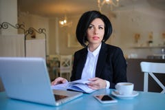 Business lady dressed in black suit working on a laptop Stock Photo Business lady dressed in black suit working on a laptop Stock Photo