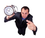 Business Man with Clock. A business man pointing to a clock isolated on white background Royalty Free Stock Photos Business Man with Clock. A business man pointing to a clock isolated on white background Royalty Free Stock Photos