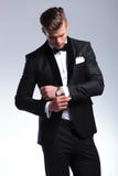 Business man looks at his cufflinks royalty free stock photos Business man looks at his cufflinks royalty free stock photos