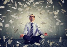 Mature business man meditating under money rain Stock Photo Mature business man meditating under money rain Stock Photo