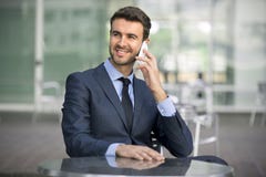 Business man sitting talking on cell phone stock photo Business man sitting talking on cell phone stock photo