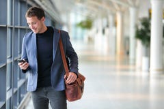 Business man using mobile phone app in airport stock photography Business man using mobile phone app in airport stock photography