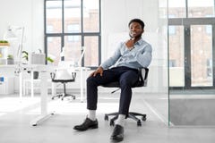 African businessman sitting on office chair Stock Photos African businessman sitting on office chair Stock Photos