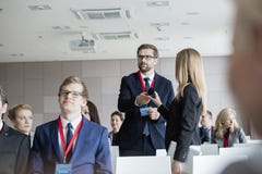 Business people holding microphone while standing during seminar royalty free stock images Business people holding microphone while standing during seminar royalty free stock images