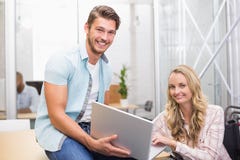 Business people smiling and working together with a laptop Stock Images Business people smiling and working together with a laptop Stock Images