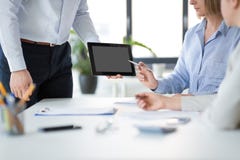 Close up of business team with tablet pc at office stock image Close up of business team with tablet pc at office stock image