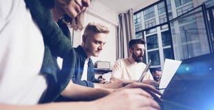 Business professionals at working moments. Group of young confident coworking people analyzing data using computer while royalty free stock photo Business professionals at working moments. Group of young confident coworking people analyzing data using computer while royalty free stock photo