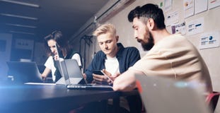 Business professionals at working moments. Group of young confident coworking people analyzing data using computer while royalty free stock photography Business professionals at working moments. Group of young confident coworking people analyzing data using computer while royalty free stock photography