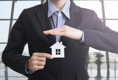 Business salesman hand holding home insurance. stock images Business salesman hand holding home insurance. stock images