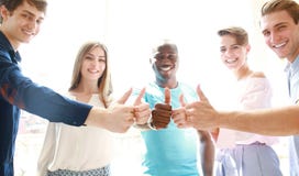 Business, startup and office concept - happy creative team showing thumbs up in office. royalty free stock images Business, startup and office concept - happy creative team showing thumbs up in office. royalty free stock images