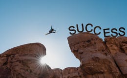 Business success, challenge, achievement and leadership concept. Silhouette a man jumping over precipice to success