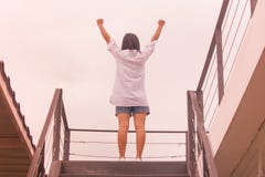 Business Success Concept : Asian woman standing on top of stair and raise up her hands. stock photography Business Success Concept : Asian woman standing on top of stair and raise up her hands. stock photography