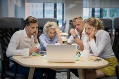 Business team looking at computer with shocked expressions royalty free stock photos Business team looking at computer with shocked expressions royalty free stock photos