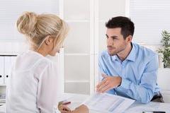 Business team sitting at desk in a meeting talking about financi stock photo Business team sitting at desk in a meeting talking about financi stock photo