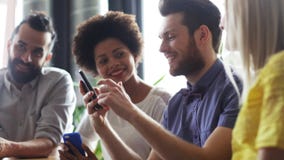 Business team with smartphones and tablet pc stock footage Business team with smartphones and tablet pc stock footage