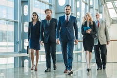 Business team walking in glass building stock photo Business team walking in glass building stock photo