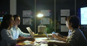 Business team working late through the night. Casual young people in architecture company. stock footage Business team working late through the night. Casual young people in architecture company. stock footage