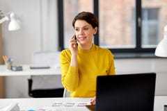 Ui designer calling on smartphone at office stock images Ui designer calling on smartphone at office stock images