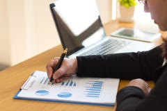 Business woman analyzes monthly business graph. stock image Business woman analyzes monthly business graph. stock image