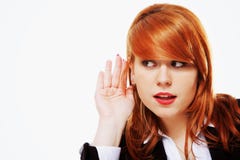 Business woman with hand to ear listening isolated Stock Image Business woman with hand to ear listening isolated Stock Image