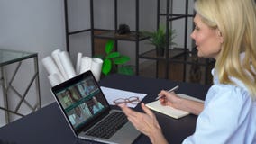 Business woman having virtual team meeting on video conference call.