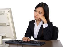 Business woman is looking stressed as she works at her computer stock photos Business woman is looking stressed as she works at her computer stock photos