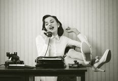 Woman talking on phone at desk