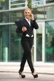Business woman talking on mobile phone outside the office Stock Photography Business woman talking on mobile phone outside the office Stock Photography