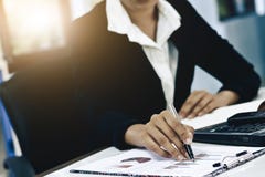 Business women Close-up hand with paper writing at graph. royalty free stock photography Business women Close-up hand with paper writing at graph. royalty free stock photography