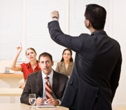 Businessman answering questions in meeting stock images Businessman answering questions in meeting stock images