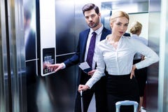 businessman and businesswoman in hotel elevator looking stock photography businessman and businesswoman in hotel elevator looking stock photography