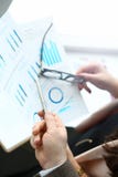 Businessman and businesswoman review graph stock photo Businessman and businesswoman review graph stock photo