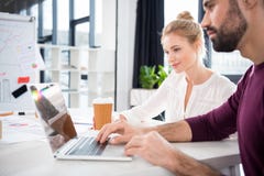 Businessman and businesswoman working with laptop together on workplace in office royalty free stock photography Businessman and businesswoman working with laptop together on workplace in office royalty free stock photography