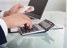 Businessman calculating expense in office royalty free stock photos Businessman calculating expense in office royalty free stock photos