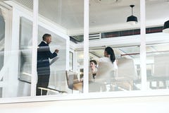 Businessman giving a presentation in modern office with glass walls stock photography Businessman giving a presentation in modern office with glass walls stock photography
