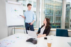 Businessman Giving Presentation To Coworker In Office stock image Businessman Giving Presentation To Coworker In Office stock image