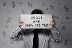 Businessman with Goods and services tax text on the paper Stock Image Businessman with Goods and services tax text on the paper Stock Image
