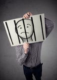 Businessman holding a paper with a prisoner behind the bars on i Royalty Free Stock Photos Businessman holding a paper with a prisoner behind the bars on i Royalty Free Stock Photos