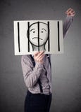 Businessman holding a paper with a prisoner behind the bars on i Stock Photography Businessman holding a paper with a prisoner behind the bars on i Stock Photography