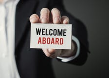 Businessman holding paper with text Welcome Aboard. Businessman holding card. royalty free stock photos Businessman holding paper with text Welcome Aboard. Businessman holding card. royalty free stock photos
