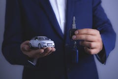 Businessman holds car and keys royalty free stock photos Businessman holds car and keys royalty free stock photos