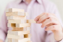 Businessman playing with blocks stock image Businessman playing with blocks stock image