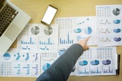Businessman pointing documents at office working table with smart phone and computer, Top view. royalty free stock photos Businessman pointing documents at office working table with smart phone and computer, Top view. royalty free stock photos