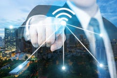 Businessman push wifi icon on city and network connection concept. Bangkok smart city and wireless communication network, abstract stock images Businessman push wifi icon on city and network connection concept. Bangkok smart city and wireless communication network, abstract stock images