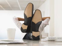 Businessman Reclining With His Feet Up On Desk Stock Photos
