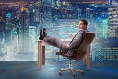 The businessman relaxing in the office Stock Photos The businessman relaxing in the office Stock Photos