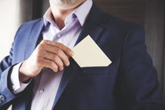 Businessman showing white card in pocket royalty free stock photography Businessman showing white card in pocket royalty free stock photography