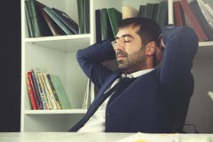 Businessman sitting in office stock photo Businessman sitting in office stock photo